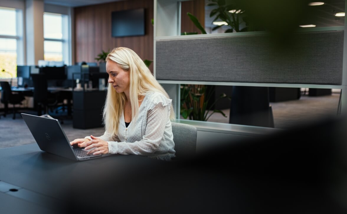 AO medarbejder arbejder foran computer på kontor